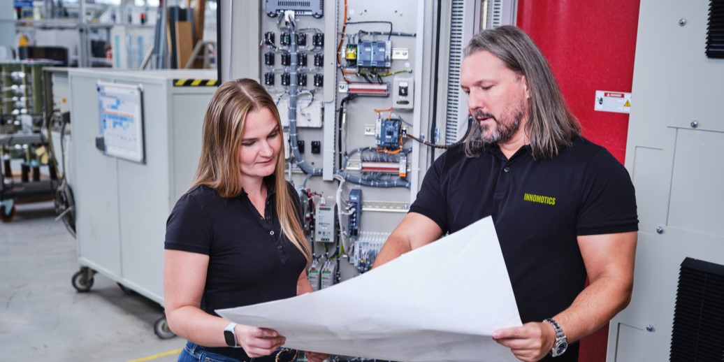 two innomotics employees looking at a plan together two innomotics employees looking at a plan together